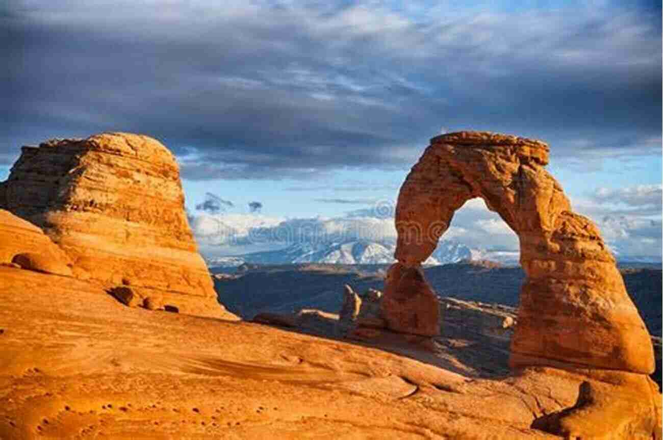 Photograph Of Landscape Arch, Capturing Its Delicate And Graceful Structure. The Warm Sunlight Highlights Its Thin, Weathered Features. Arches National Park: Photographs Of Arches National Park