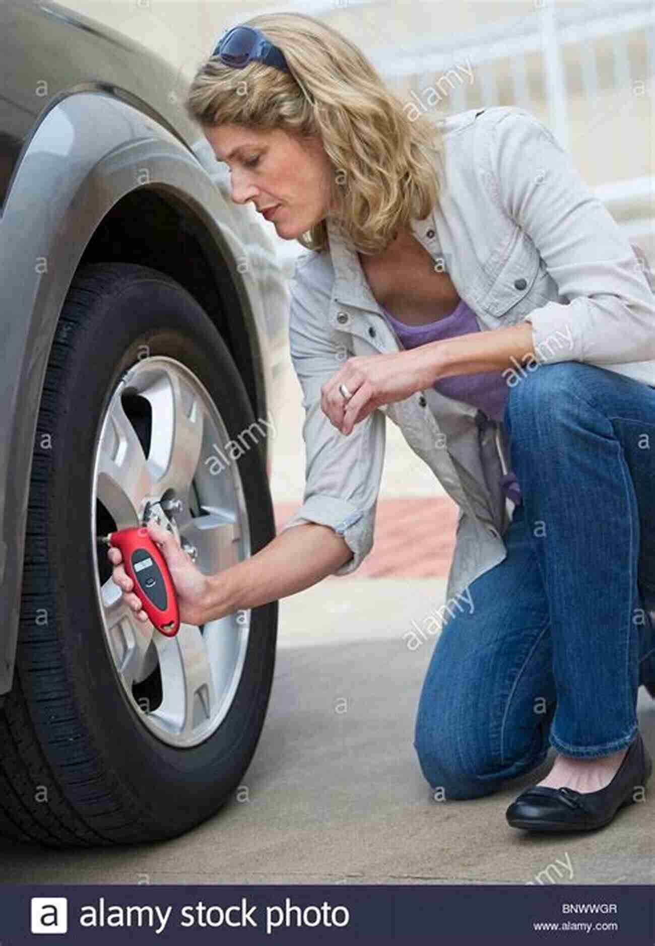 Woman Checking Tire Pressure During MOT Test Pass The MoT Test How To Check Prepare Your Car For The Annual MoT Test (RAC Handbook)